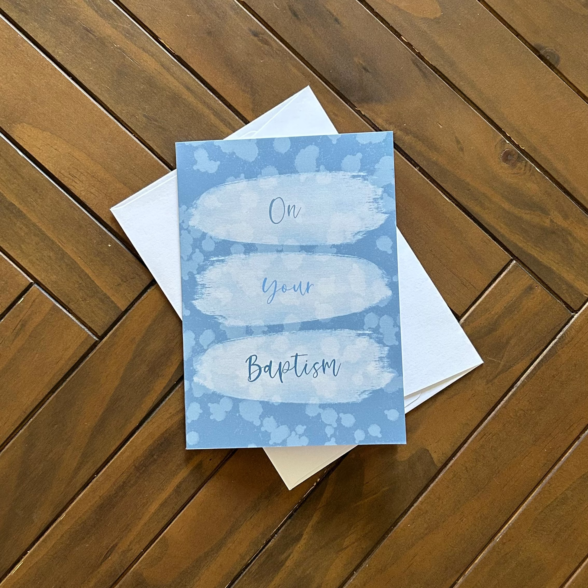 Greeting card with 'On Your Baptism' text on a wooden surface