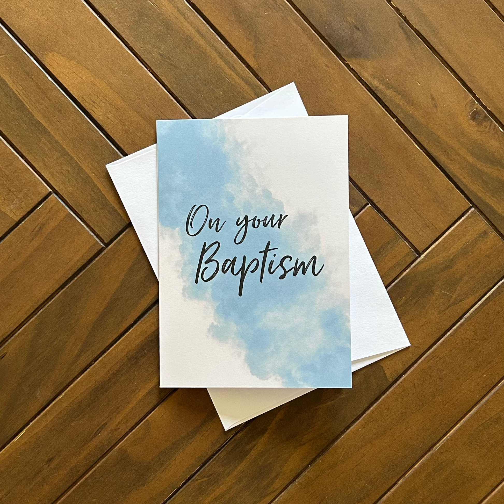 Greeting card with 'On your Baptism' text on a wooden surface