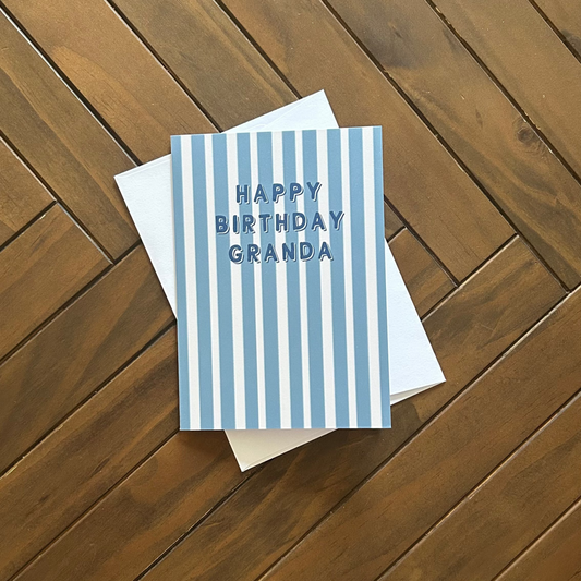 GRANDA birthday card with blue stripes on a wooden surface